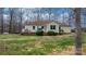 Rear exterior featuring a white deck, manicured lawn, and serene surroundings at 920 Hunting Ave, Lincolnton, NC 28092