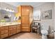 Well-lit bathroom with wooden cabinets, a large mirror, vanity lighting, and a decorative corner cabinet at 920 Hunting Ave, Lincolnton, NC 28092