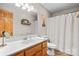 Bathroom with wood look floors, wood vanity, white countertops and toilet, and updated fixtures at 920 Hunting Ave, Lincolnton, NC 28092