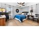 Comfortable bedroom with a blue bedspread, wood-look floors, and ample natural light from the window at 920 Hunting Ave, Lincolnton, NC 28092