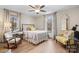 Bright bedroom featuring hardwood floors, a queen-size bed, and natural light from the large window at 920 Hunting Ave, Lincolnton, NC 28092