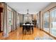 Elegant dining room with large windows, hardwood floors, and a modern chandelier creating a perfect ambiance for Gathering meals at 920 Hunting Ave, Lincolnton, NC 28092