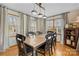 Bright dining room with hardwood floors, a wooden table, six chairs, and natural light from the windows at 920 Hunting Ave, Lincolnton, NC 28092