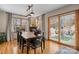Sunlit dining room features wood floors, a wooden table with six chairs, and sliding doors to the back patio at 920 Hunting Ave, Lincolnton, NC 28092