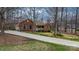 Attractive brick home featuring blue shutters, lush lawn, and a long driveway at 920 Hunting Ave, Lincolnton, NC 28092