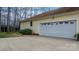 Side view of home with a spacious garage and a manicured lawn at 920 Hunting Ave, Lincolnton, NC 28092
