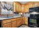 Beautiful kitchen showcasing granite countertops, a modern sink, wood cabinets, and modern black appliances at 920 Hunting Ave, Lincolnton, NC 28092