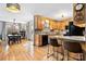 Charming kitchen with wooden cabinets, granite countertops, stainless steel appliances, and a cozy breakfast bar overlooking the dining area at 920 Hunting Ave, Lincolnton, NC 28092