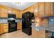 Contemporary kitchen equipped with modern appliances, wooden cabinets, a stylish backsplash, and an integrated microwave at 920 Hunting Ave, Lincolnton, NC 28092