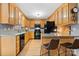 Well-appointed kitchen featuring granite countertops, wooden cabinets, and modern black appliances, enhanced by stylish backsplash at 920 Hunting Ave, Lincolnton, NC 28092