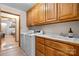Functional laundry room with ample cabinet space, a sink, a washer, and a dryer at 920 Hunting Ave, Lincolnton, NC 28092
