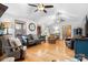 Bright living room with hardwood floors, neutral-toned furniture, ceiling fans, and large windows offering plenty of natural light at 920 Hunting Ave, Lincolnton, NC 28092