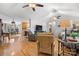 Inviting living room featuring hardwood floors, ceiling fans, and ample natural light flowing into the open-concept space at 920 Hunting Ave, Lincolnton, NC 28092