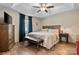 Spacious main bedroom boasts wood floors, a tray ceiling, and warm, inviting decor at 920 Hunting Ave, Lincolnton, NC 28092