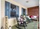 Inviting porch with rocking chairs and a brick accent wall, perfect for relaxing outdoors at 920 Hunting Ave, Lincolnton, NC 28092