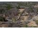 An aerial view shows a home in a wooded neighborhood, highlighting its location and surrounding landscape at 939 Dameron Rd, Bessemer City, NC 28016
