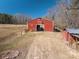 Exterior view of the red barn with a metal gate, a smaller shed, and a cleared grassy field at 939 Dameron Rd, Bessemer City, NC 28016