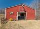 Exterior of the red barn with open gate and small garden to the left at 939 Dameron Rd, Bessemer City, NC 28016