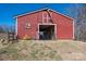 Exterior of the red barn with open gate and small garden to the left at 939 Dameron Rd, Bessemer City, NC 28016