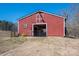 Exterior of the red barn with open gate and small garden to the left at 939 Dameron Rd, Bessemer City, NC 28016