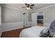 Bedroom featuring hardwood floors, ceiling fan, and access to the kitchen, creating a comfortable and inviting space at 939 Dameron Rd, Bessemer City, NC 28016