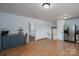 Bright dining area featuring a coffee bar, stainless steel refrigerator, and hardwood floors at 939 Dameron Rd, Bessemer City, NC 28016