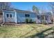 The house features charming curb appeal with manicured lawn, light-blue siding, and a decorative windmill at 939 Dameron Rd, Bessemer City, NC 28016