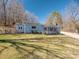 Charming home featuring a well-maintained lawn, quaint front porch, and light blue horizontal siding at 939 Dameron Rd, Bessemer City, NC 28016
