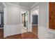 Hallway with two open doorways, one into a bathroom and the other into a bedroom, hardwood floors at 939 Dameron Rd, Bessemer City, NC 28016