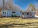 Charming home exterior with a inviting porch, well maintained landscaping, and blue siding at 939 Dameron Rd, Bessemer City, NC 28016