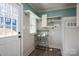 Mud room featuring white cabinets, a gray countertop, a door to the outside, and a window at 939 Dameron Rd, Bessemer City, NC 28016