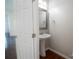 Bright bathroom features a pedestal sink, framed mirror, and hardwood floors at 9760 Springholm Dr, Charlotte, NC 28278