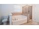 Bathroom featuring a bathtub with shower and modern fixtures at 9760 Springholm Dr, Charlotte, NC 28278