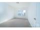 Comfortable carpeted bedroom features a window with a view at 9760 Springholm Dr, Charlotte, NC 28278