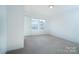 Bedroom with neutral carpet, white walls, and natural light at 9760 Springholm Dr, Charlotte, NC 28278