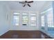 Sun-filled living room boasts hardwood floors, crisp white walls, and access to the outdoors at 9760 Springholm Dr, Charlotte, NC 28278