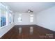 Spacious living room with gleaming hardwood floors, neutral colors, and abundant natural light at 9760 Springholm Dr, Charlotte, NC 28278