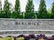 Community entrance sign surrounded by lush greenery and landscaping at 9760 Springholm Dr, Charlotte, NC 28278