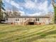Exterior of home showing back deck, windows and partially dormant lawn at 1005 Maywood St, Kannapolis, NC 28081