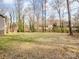 Spacious backyard with a few bare trees and sparse grass at 1005 Maywood St, Kannapolis, NC 28081