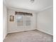 Spacious bedroom with neutral carpet, two windows, and crown molding at 1005 Maywood St, Kannapolis, NC 28081