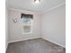 Neutral bedroom with plush carpet, ceiling fan, and a large window at 1005 Maywood St, Kannapolis, NC 28081