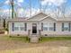 Charming single story home with vinyl siding, black shutters, and a covered front porch at 1005 Maywood St, Kannapolis, NC 28081