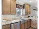 Contemporary kitchen with a stainless steel farmhouse sink, light countertops and wood cabinets at 1005 Maywood St, Kannapolis, NC 28081