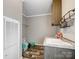 Laundry room features a utility sink with storage, and a laundry rack at 1005 Maywood St, Kannapolis, NC 28081