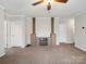 Inviting living room featuring a ceiling fan, plush carpet and a custom entertainment center at 1005 Maywood St, Kannapolis, NC 28081