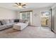 Cozy living room with plush sectional couch, ceiling fan, and a view of the outdoors at 1005 Maywood St, Kannapolis, NC 28081