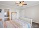 Main bedroom boasts an ensuite bathroom, ceiling fan, and neutral walls at 1005 Maywood St, Kannapolis, NC 28081