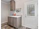 Mud room features a utility sink with storage, and access to the exterior at 1005 Maywood St, Kannapolis, NC 28081