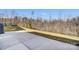 Backyard with a concrete patio area and a grassy area extending to a fenced treeline at 108 Ellsworth Rd # 40, Mooresville, NC 28115
